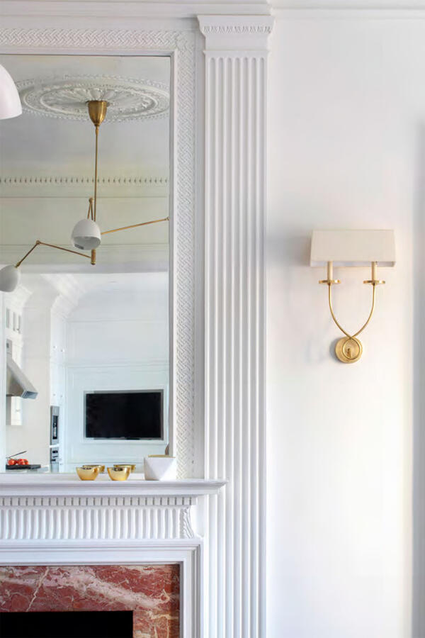 Wall with collage of dogs on brown canvas with a bookshelf to the right