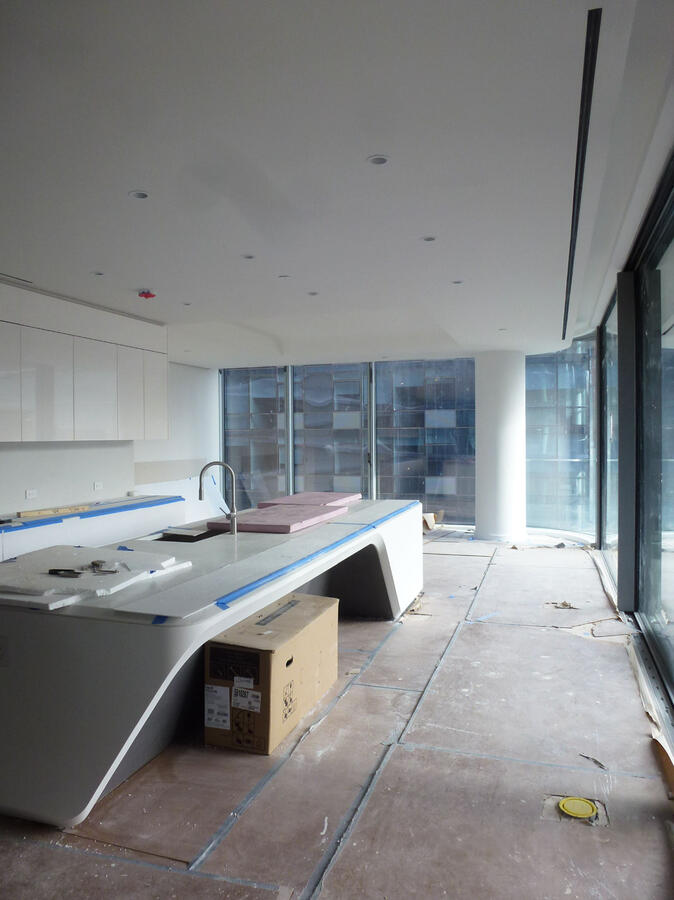 Brightly lit white kitchen with marble counters